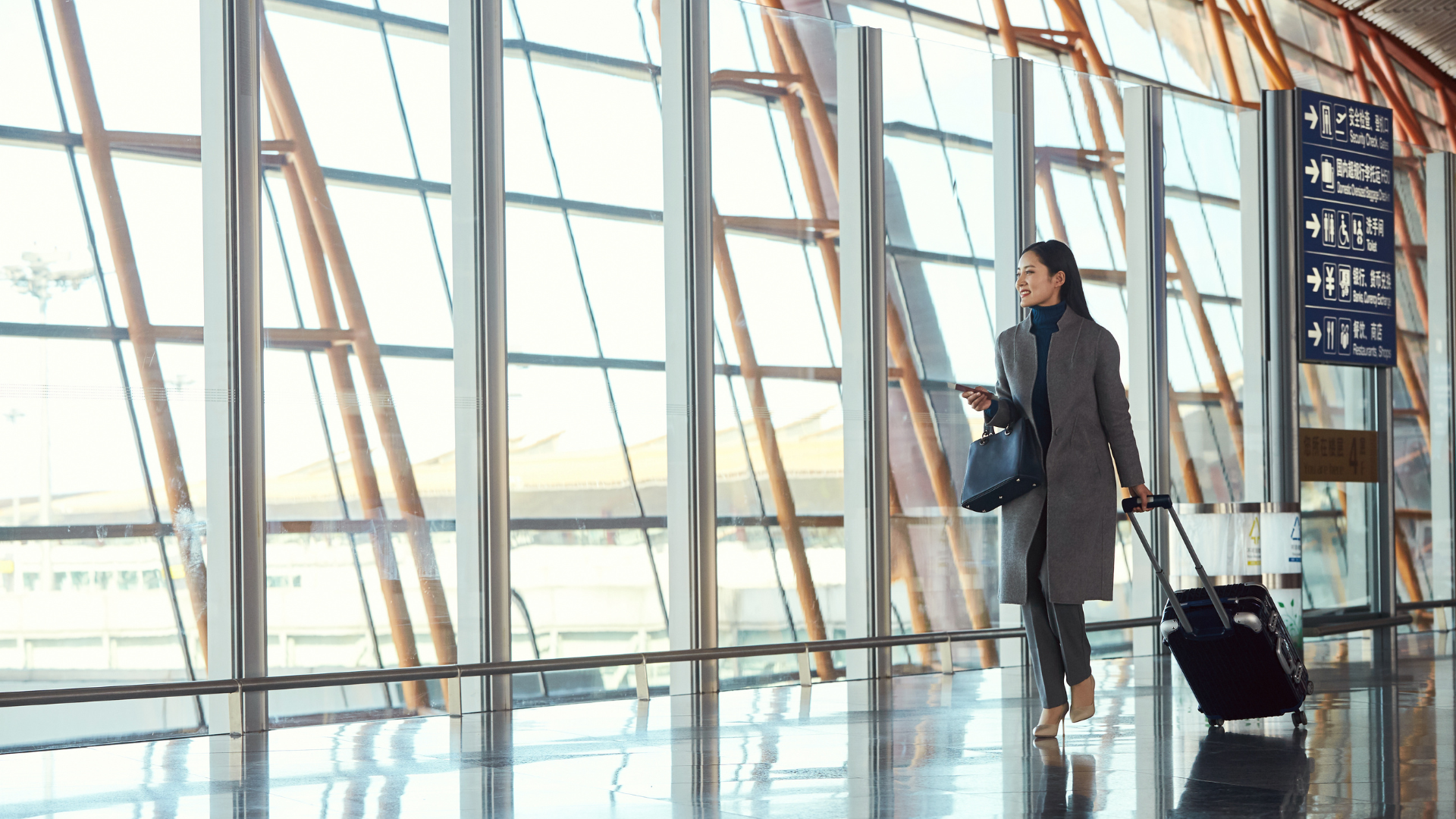 A traveller walks through an airport terminal