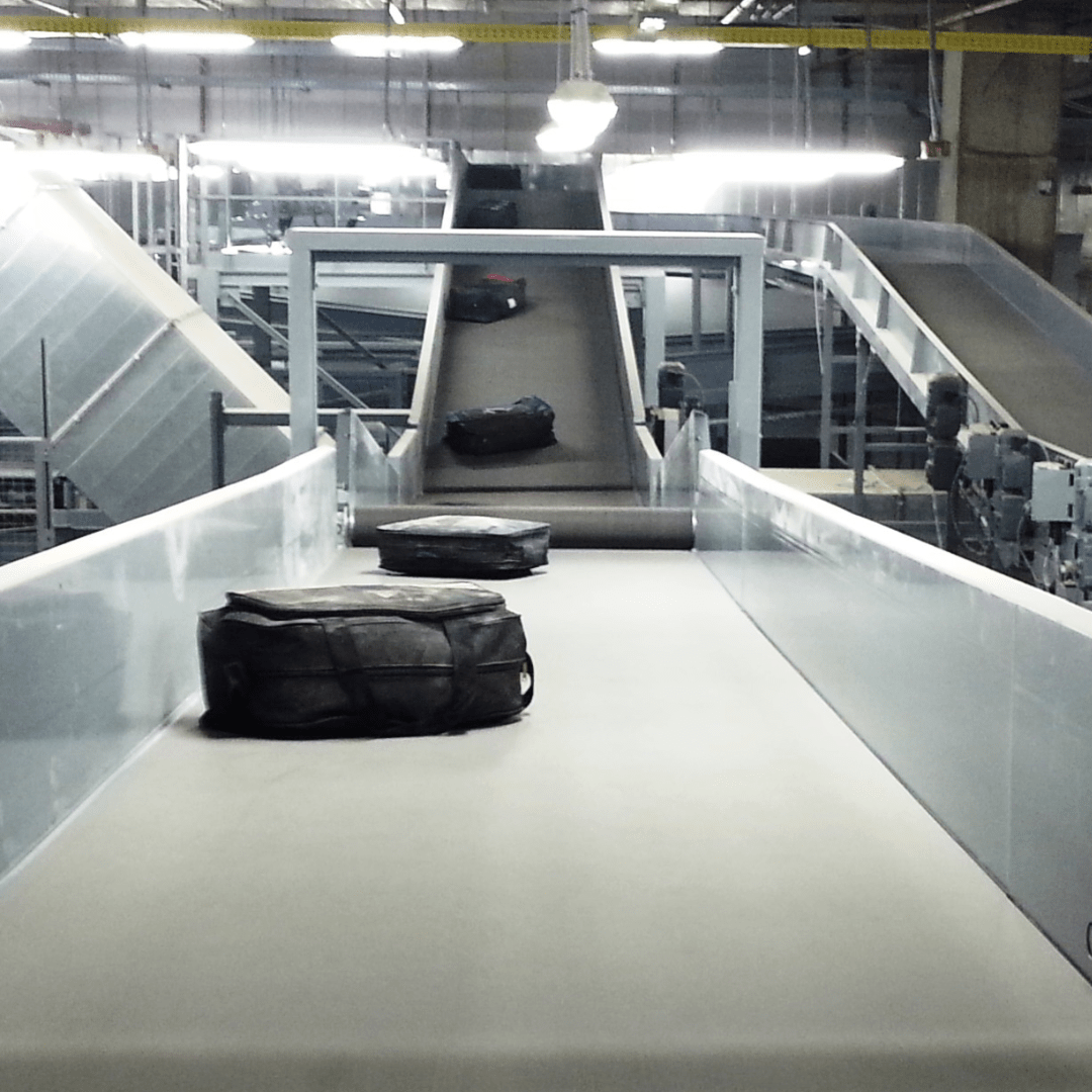 Black suitcase on a baggage conveyor belt