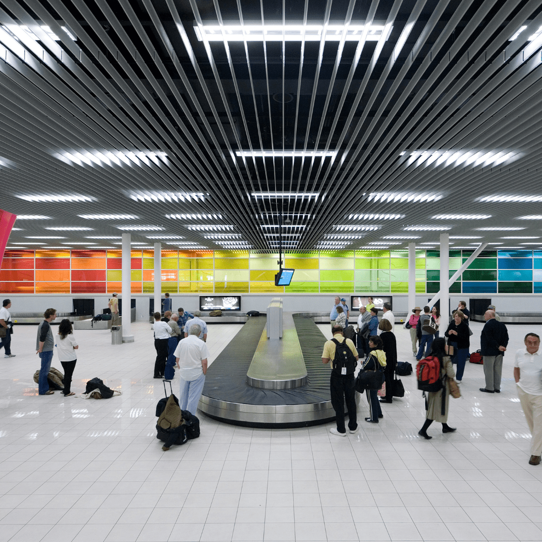 Baggage reclaim hall with people waiting for their luggage