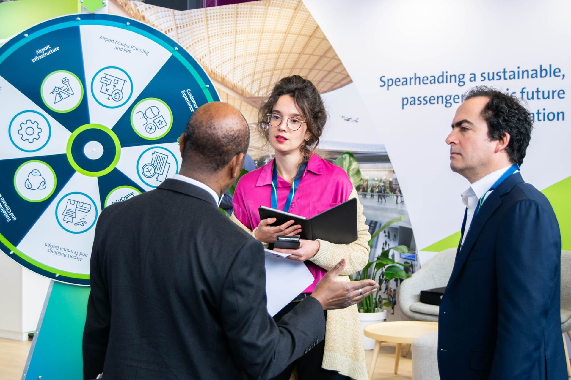 people standing next to a spinning wheel for prices