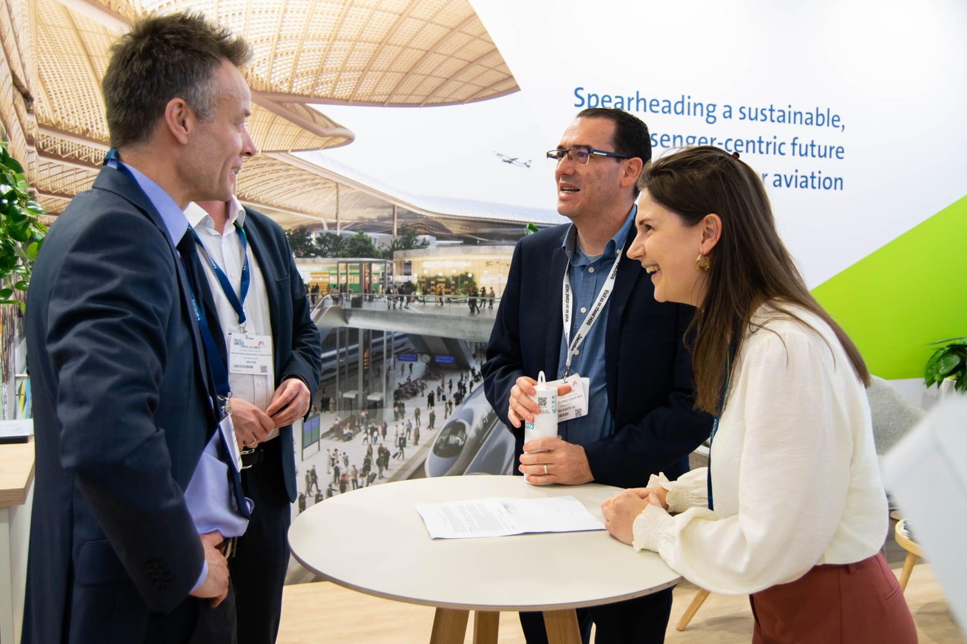 people having a conversation around a standing table