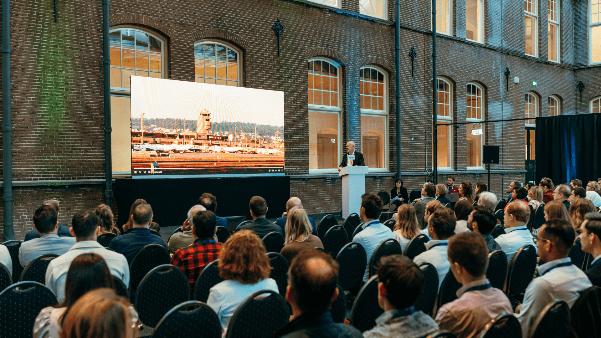 Attendees enjoy a presentation at NACO Sustainable Aviation Summit